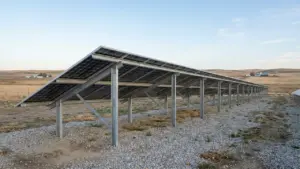 Ground-mounted bifacial solar panel array raised above light gravel